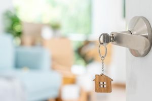 House key in a front door illustrating Georgia home insurance deductibles.
